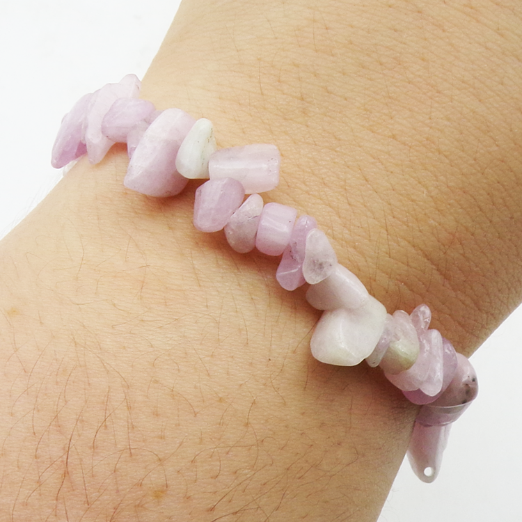 Kunzite chip bracelet made from natural irregular stone pieces on an elasticated band worn on a wrist