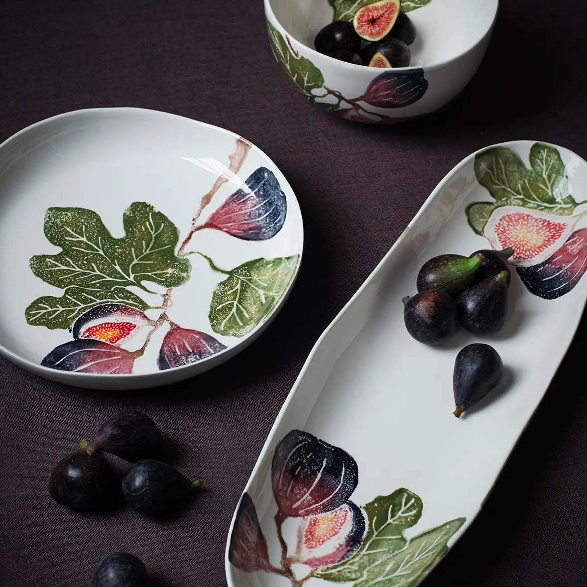 ceramic dishes with fig design on a dark background
