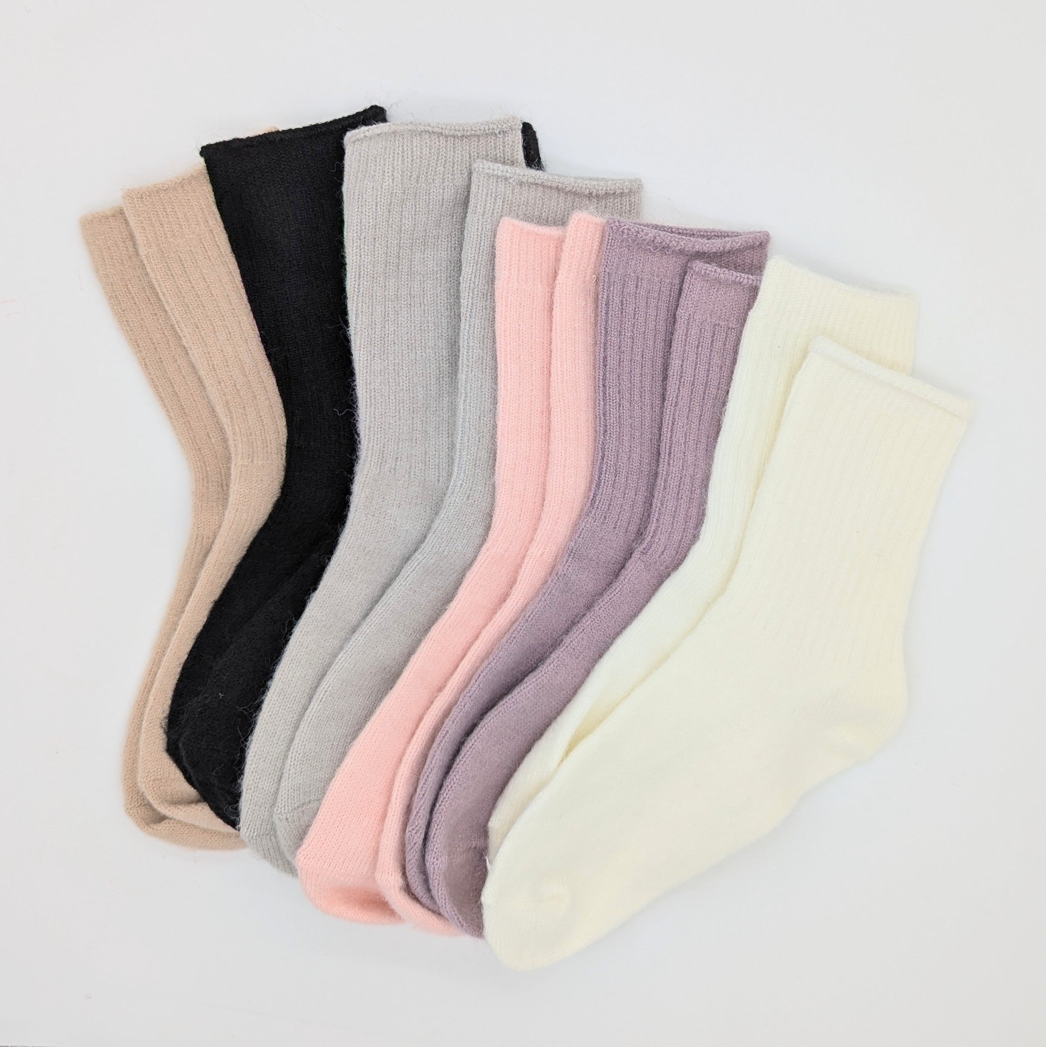 Set of colorful socks arranged in a row on a light background