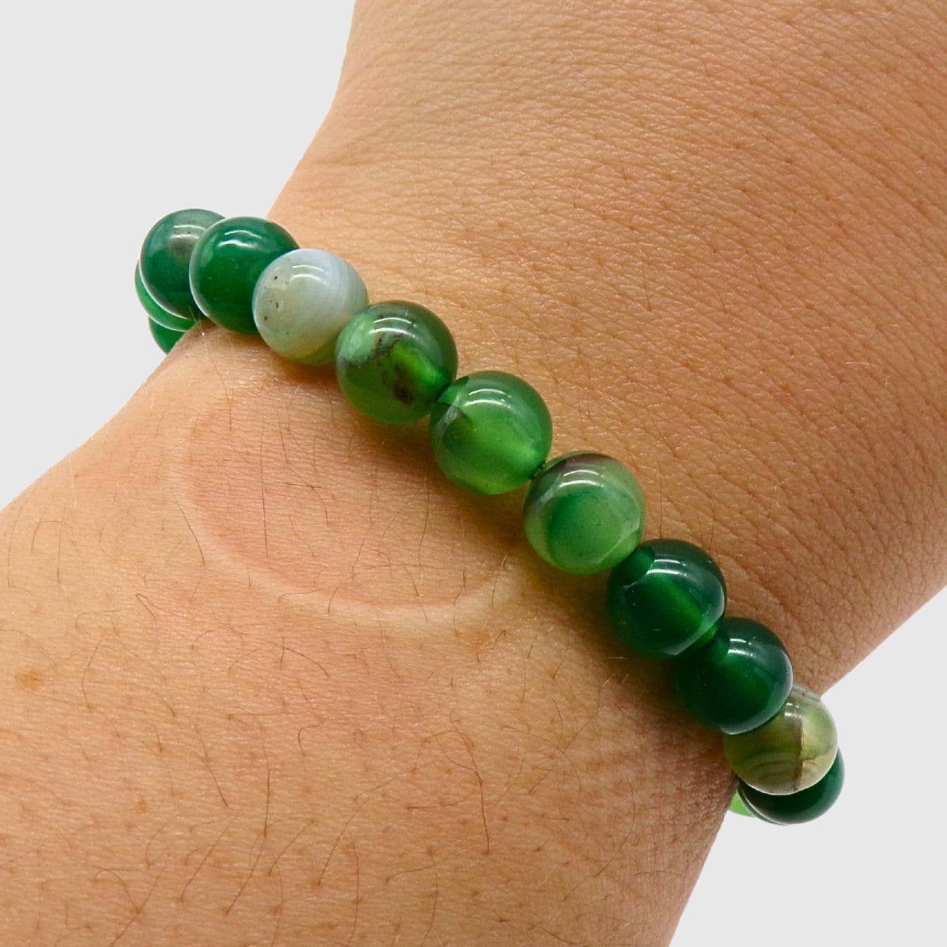 Green Agate beaded bracelet on a wrist against a white background