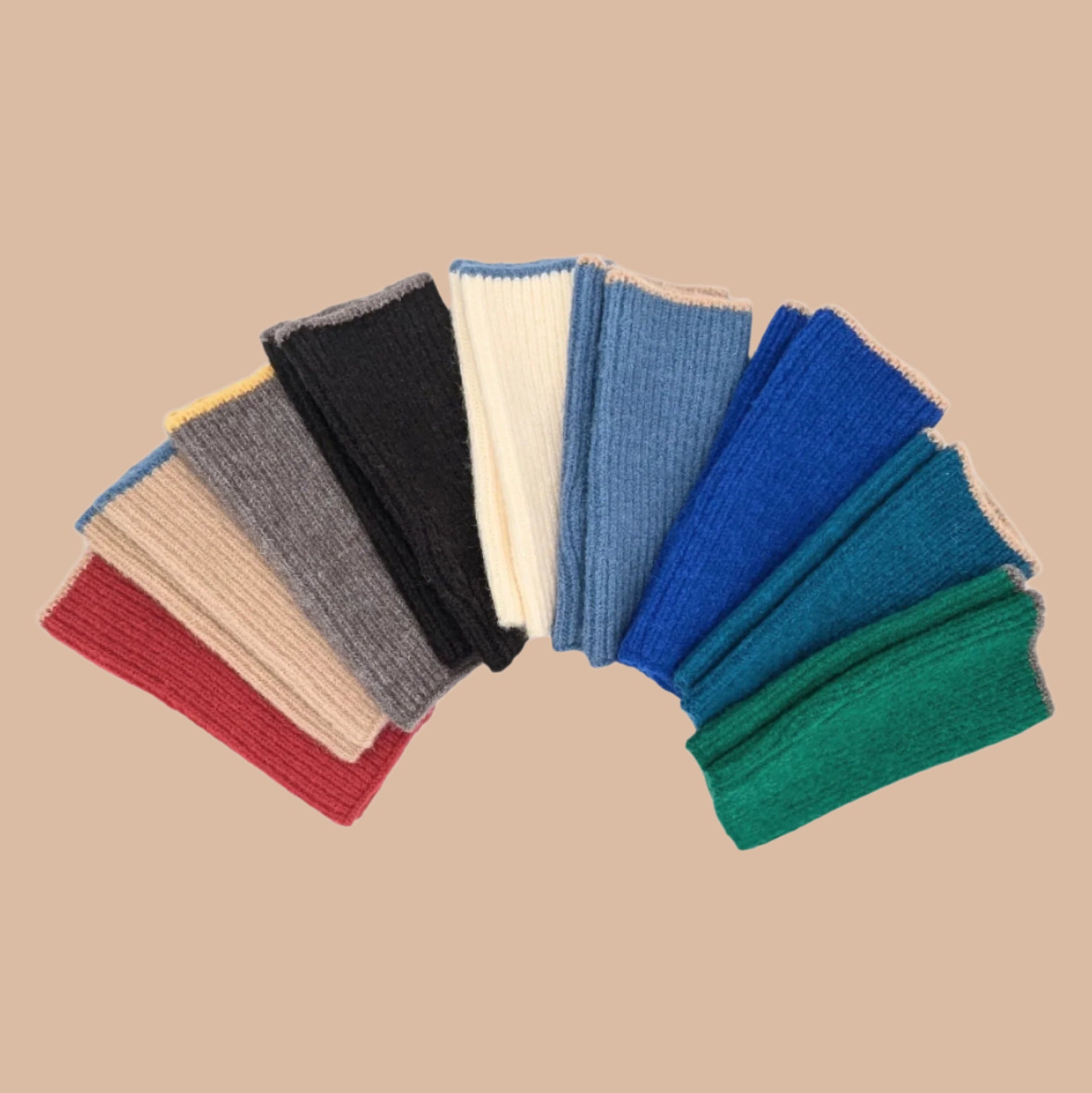 nine pairs of handwarmers side by side on white background