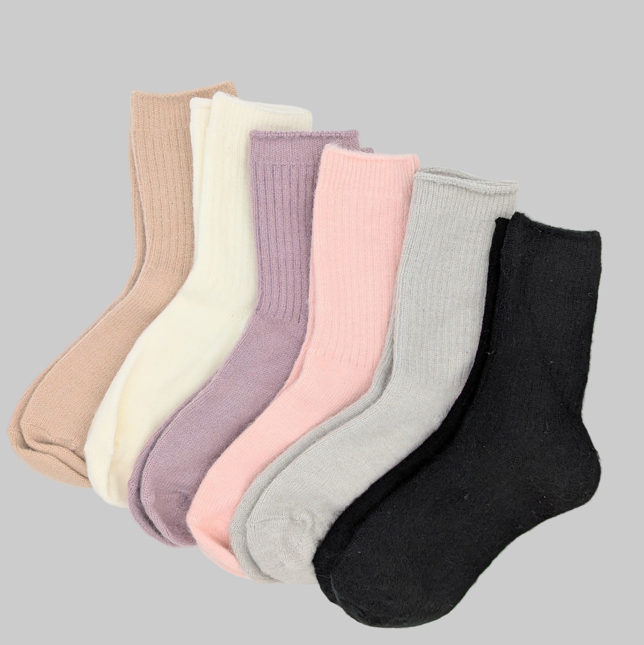 Set of six pairs of socks in various colors on a white background